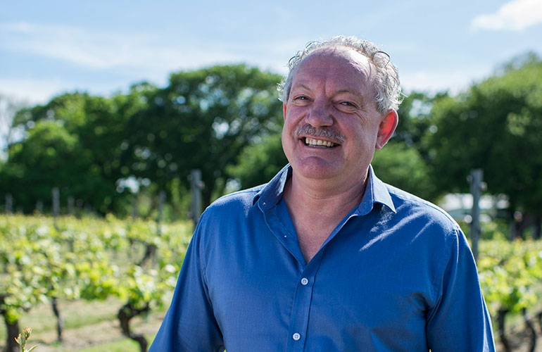 Ed Carr smiling in vineyard